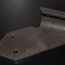 A grey metal bracket with four mounting holes.