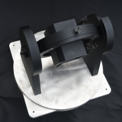 A black gimbal mount on a circular metal base.