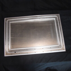 Rectangular metal access panel with a riveted flange.
