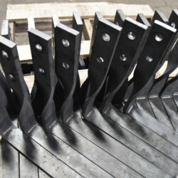 Stacked metal brackets with two bolt holes each.
